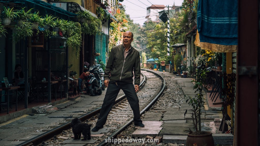 Man checking for the train at Hanoi Train Street