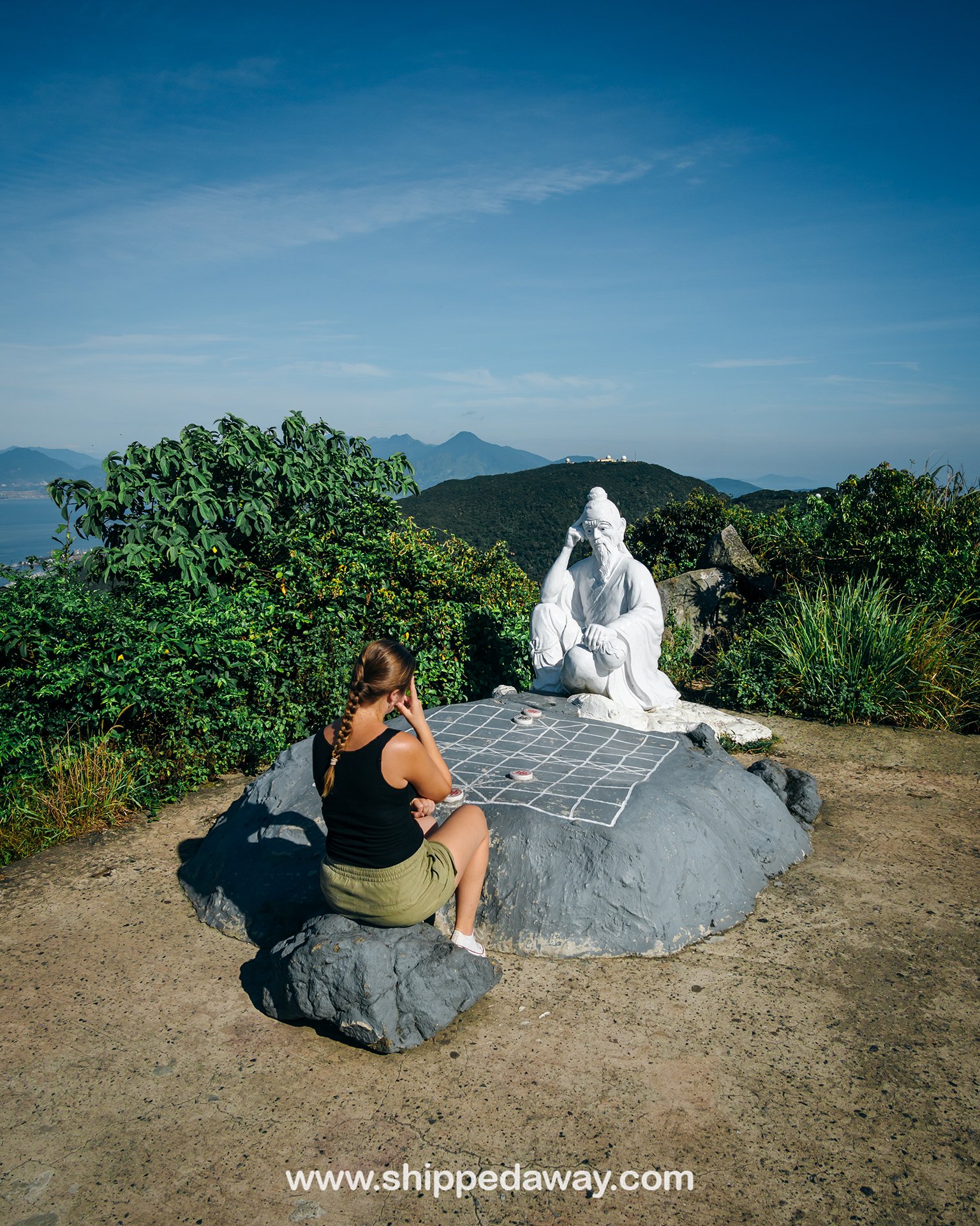 Statue of De Thich deity (the chess king) playing chess on the top of Ban Co Peak, Da Nang