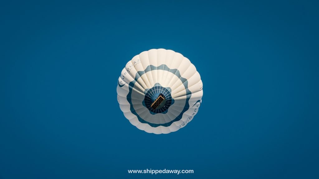 Hot air balloon flying above the people in Cappadocia
