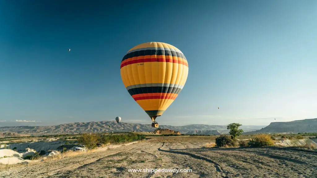 Hot air balloons fly low in Cappadocia