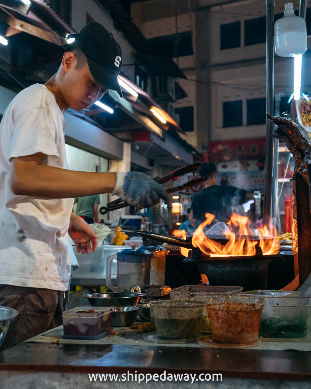 Man preparing fried noodles at Jonker Street Night Market, Melaka (Malacca), Malaysia