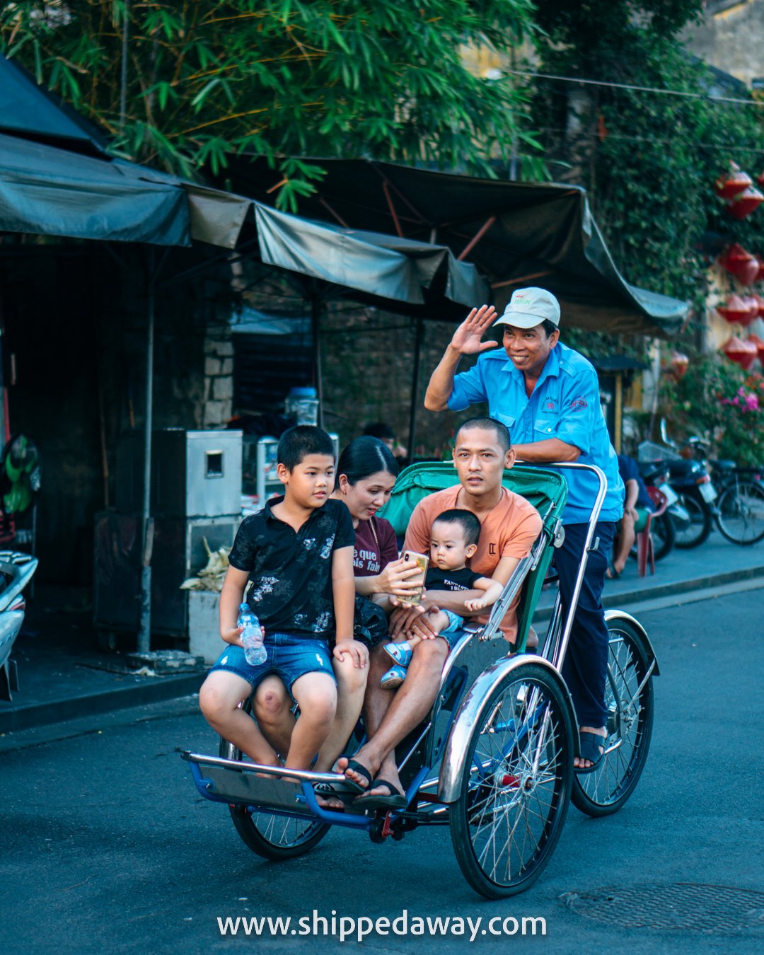 Family on a cyclo ride in Hoi An, Vietnam