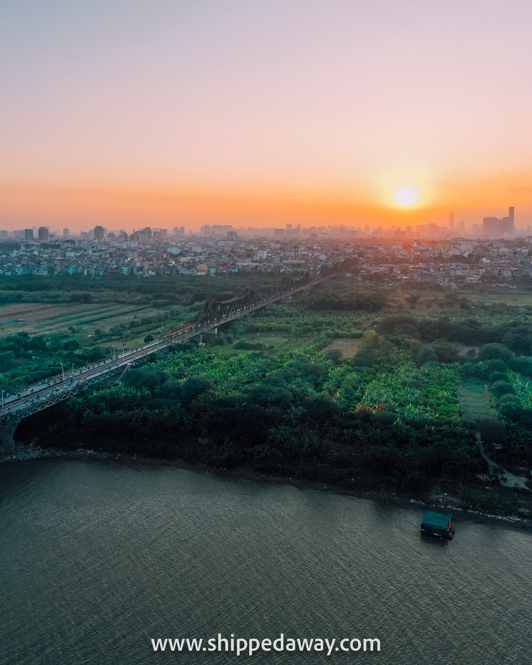 Beautiful sunset over the Long Bien Bridge and Banana Island, Hanoi, Vietnam