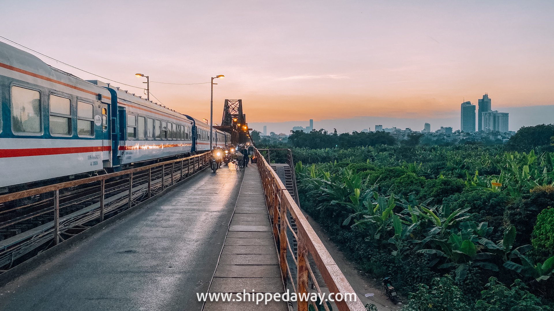 Train crossing the Long Bien Bridge over the Banana Plantations near Hanoi's Old Quarter