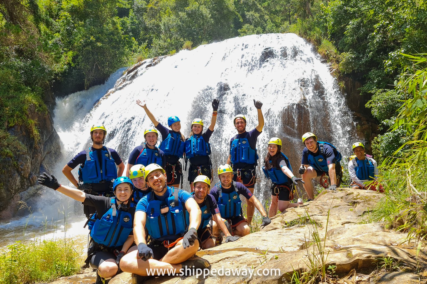Group photo by the big waterfall while canyoning in Da Lat, Vietnam