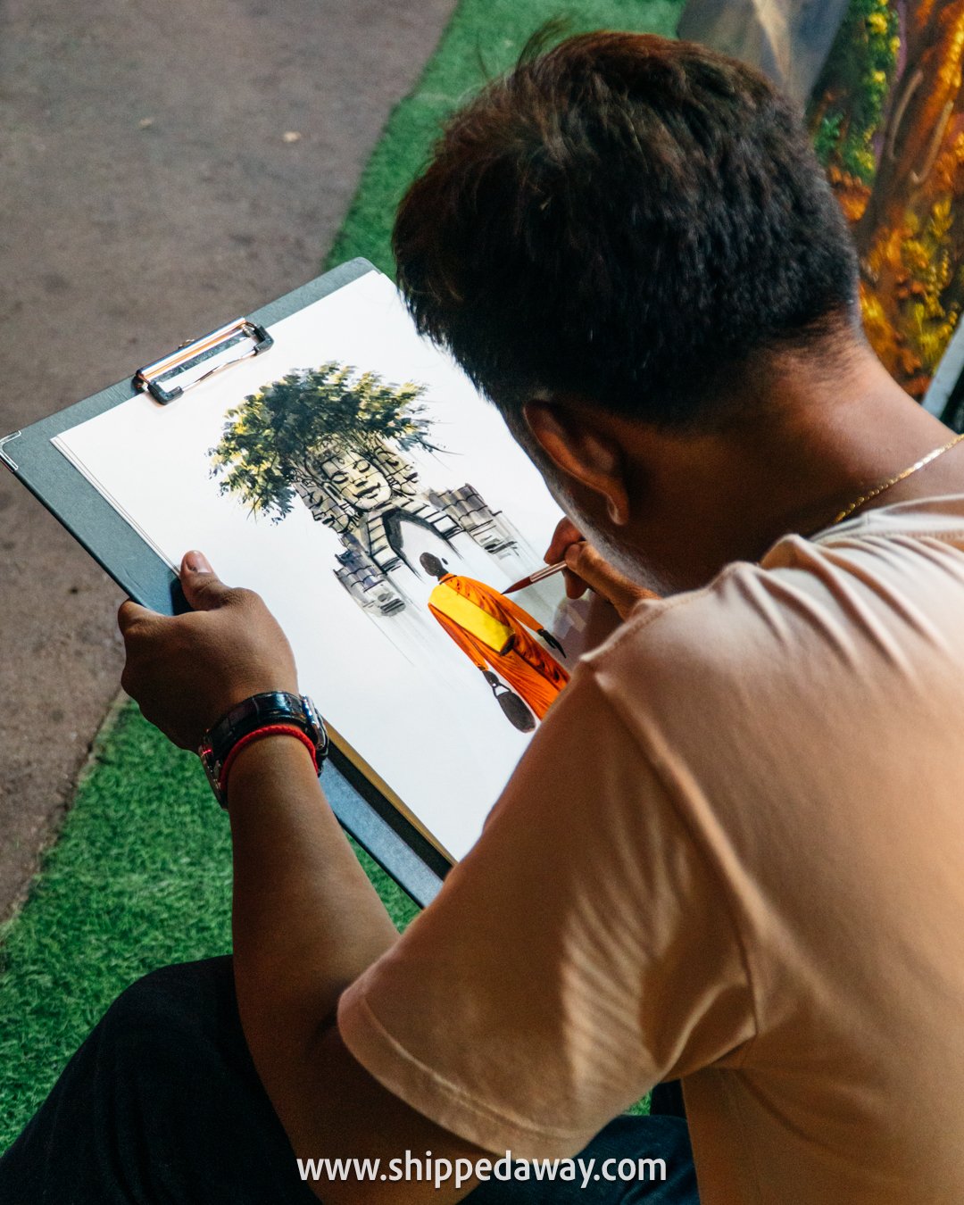 Artist painting a monk in Pub Street, Siem Reap
