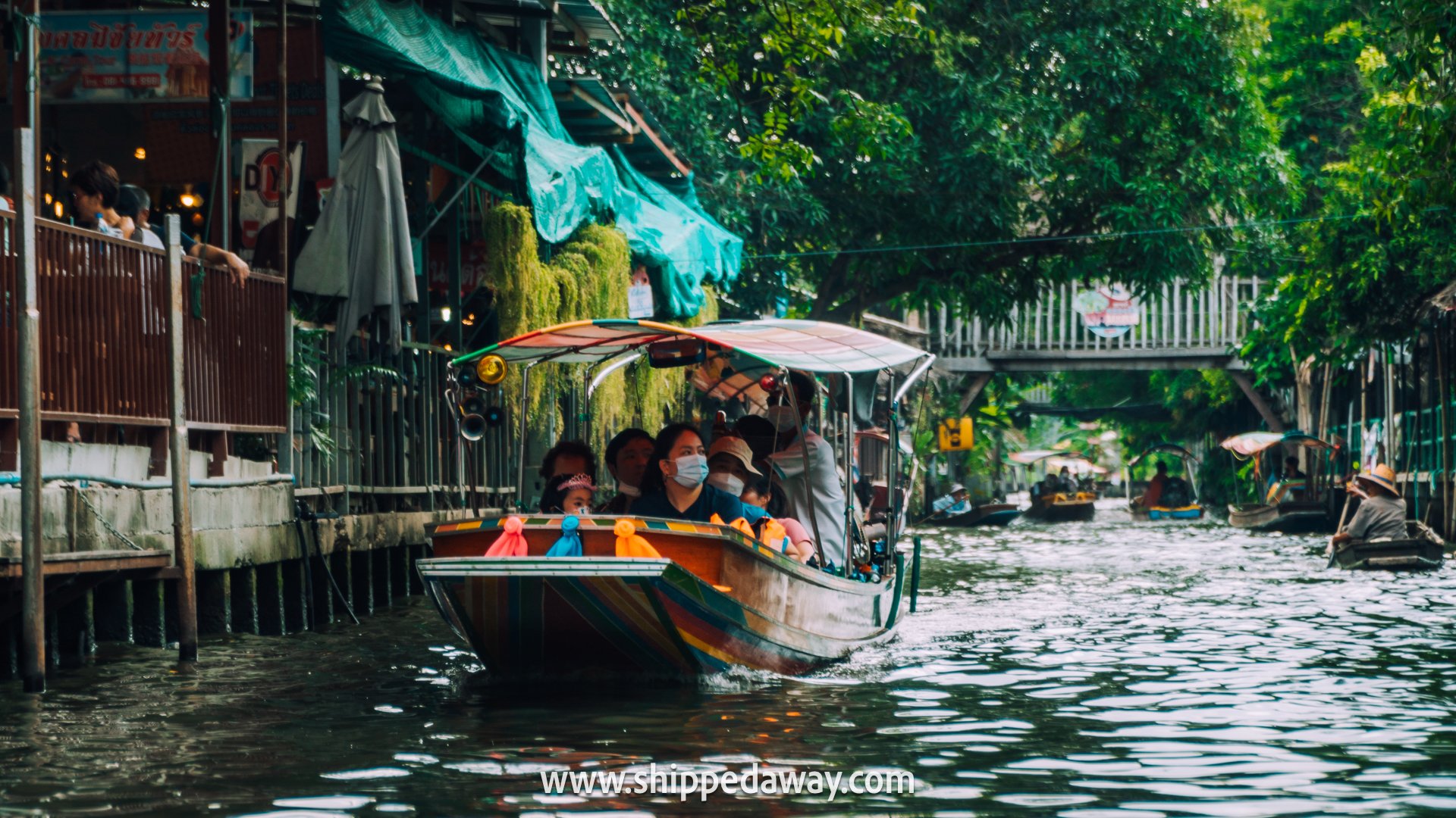 Tourits on a boat in a floating market, Bangkok, Thailand