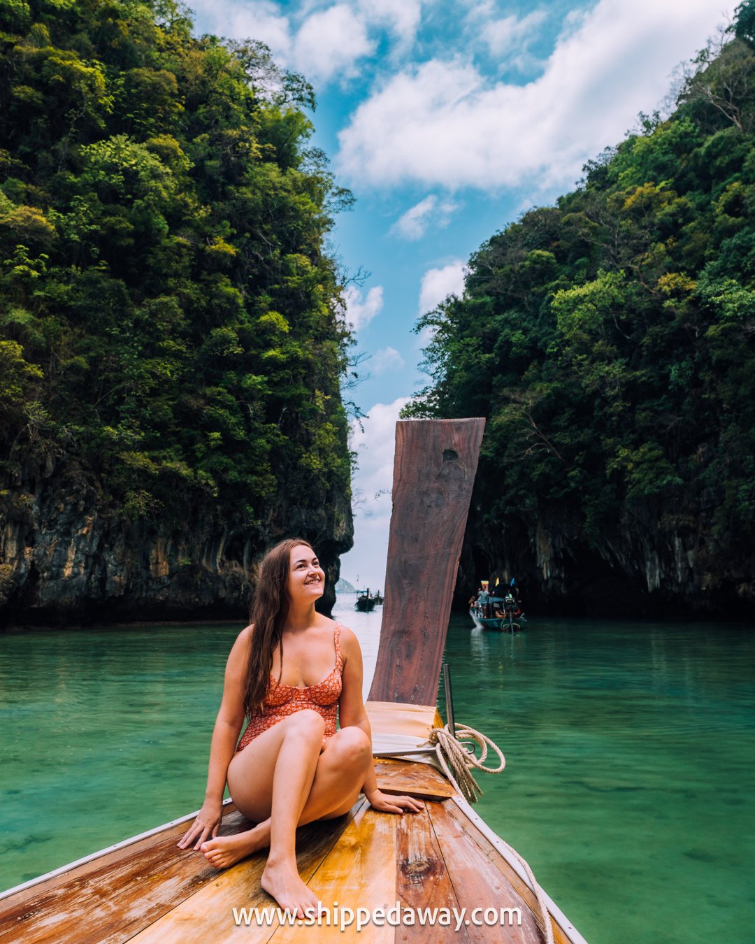 Sitting on the bow of a longtail boat in Hong Island Lagoon, Krabi