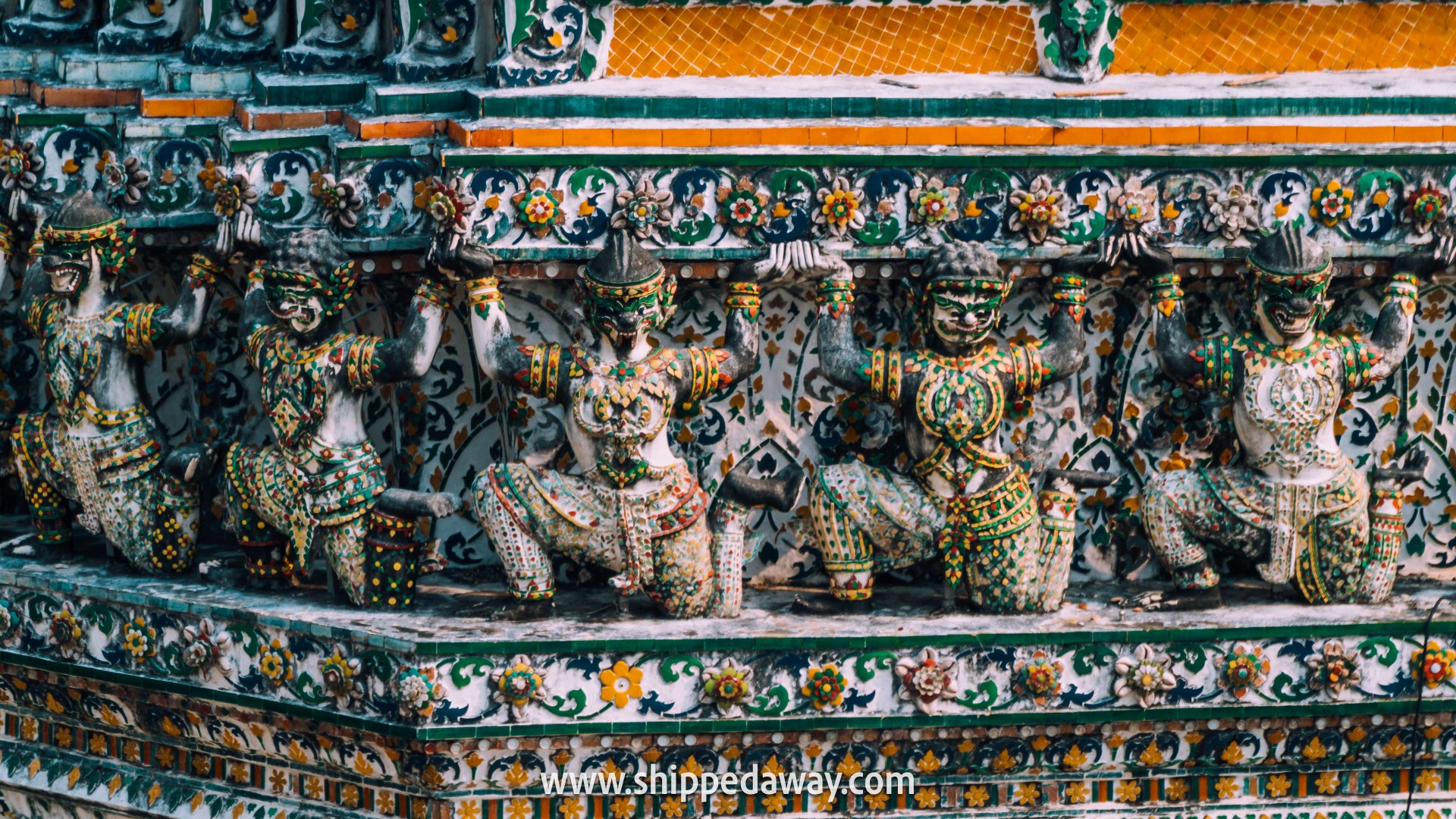 How to visit Wat Arun - Colorful porcelain and seashell mosaic detail on Wat Arun's central prang in Bangkok, Thailand