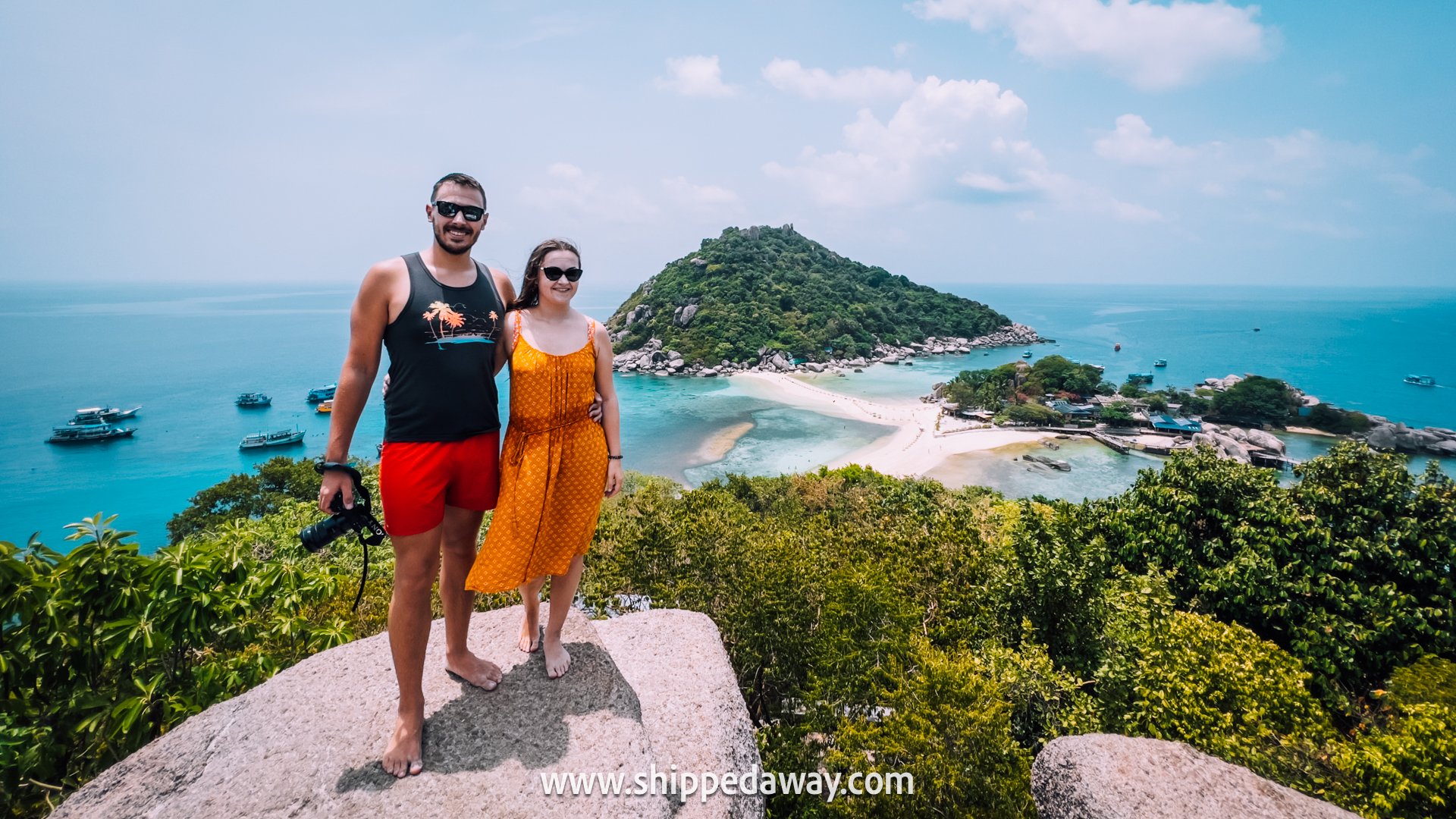 Couple posing on top of the rock at Koh Nang Yuan island viewpoint, Koh Tao, Thailand