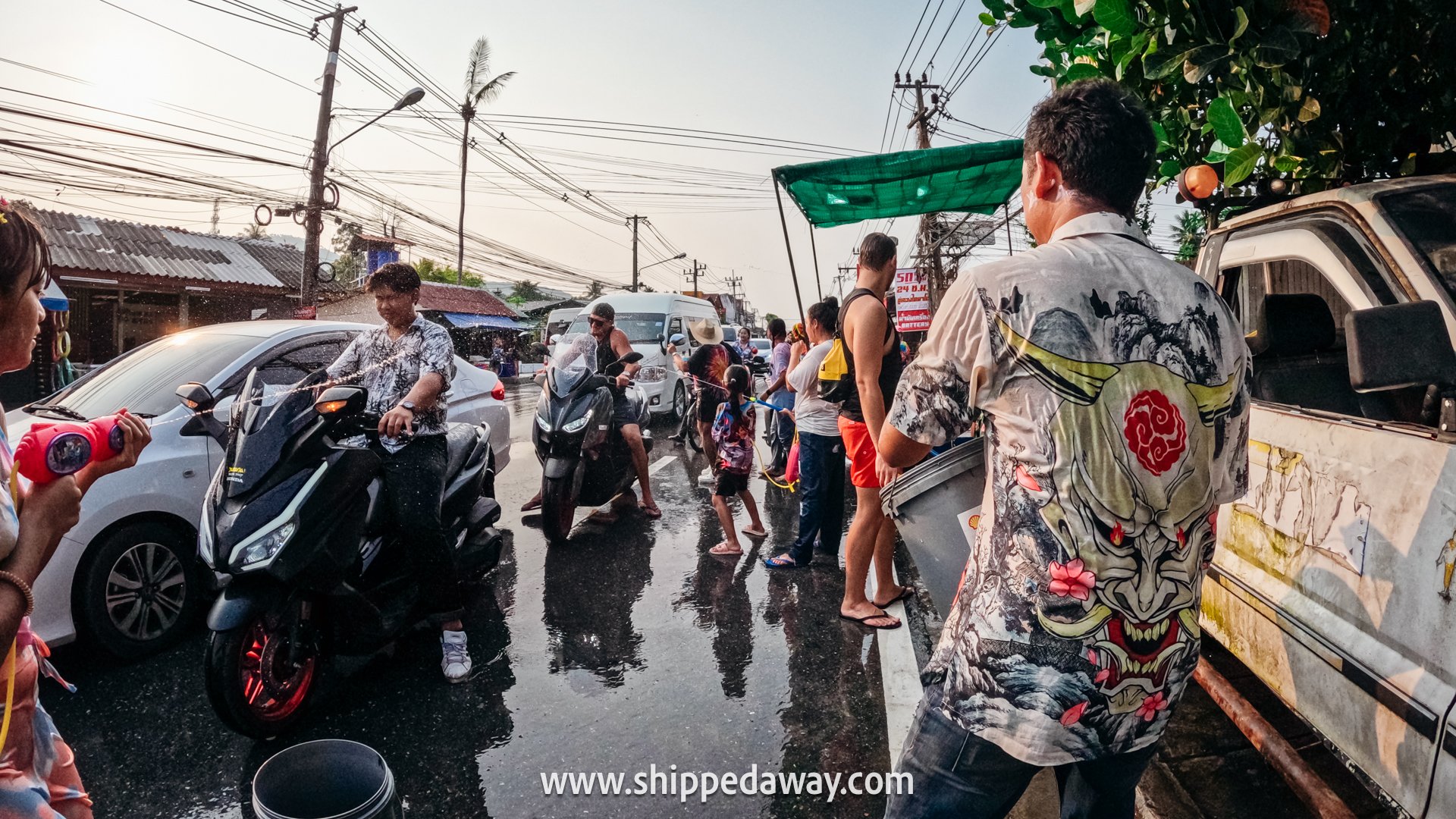 Locals splashing water on roadside during Songkran Festival Thailand - Thai New Year Water Fight