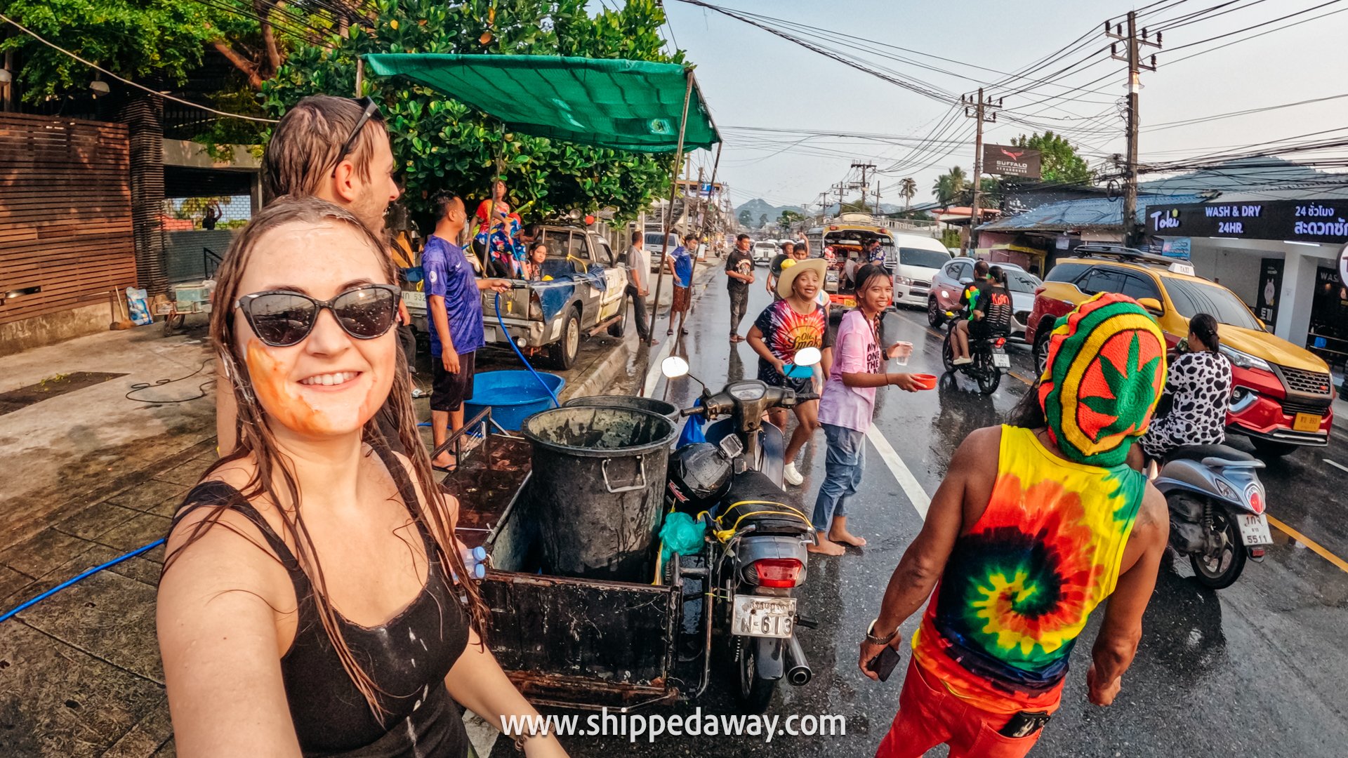 Full streets during Songkran Festival Thailand - water splashing on roadside - Thai New Year Water Festival