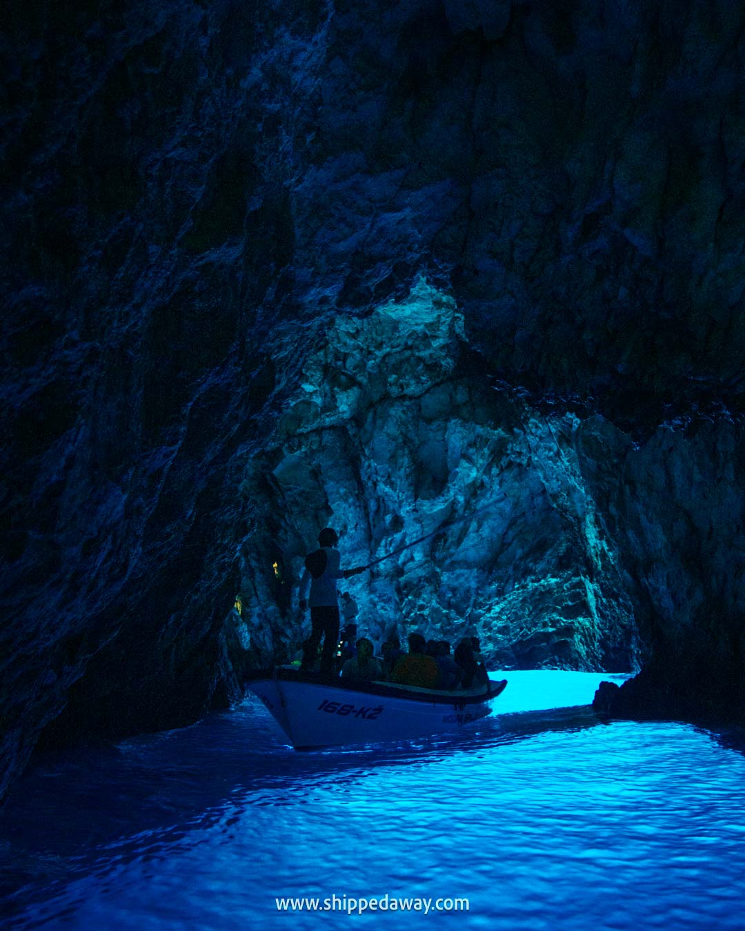 Local wooden boat inside the Blue Cave Biševo Croatia - how to visit the Blue Cave in Croatia