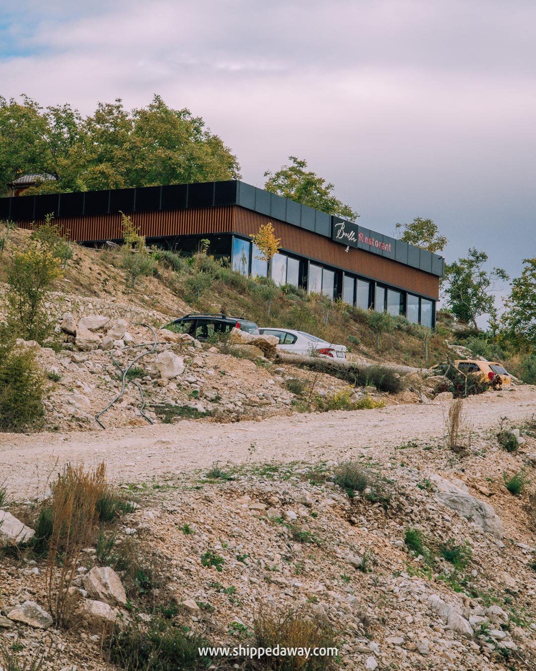 How to visit Bovilla Lake in Albania - gravel road to Bovilla restaurant