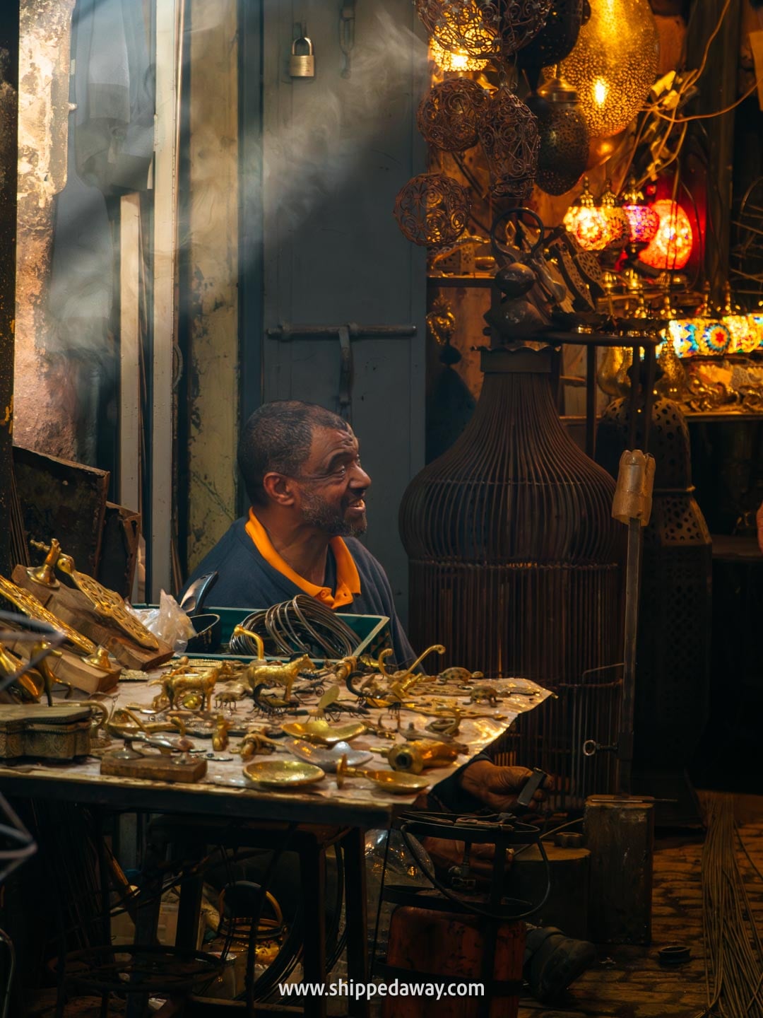 Things to do in Marrakesh, Morocco - walking through souks of the medina - a worker in the copper souk