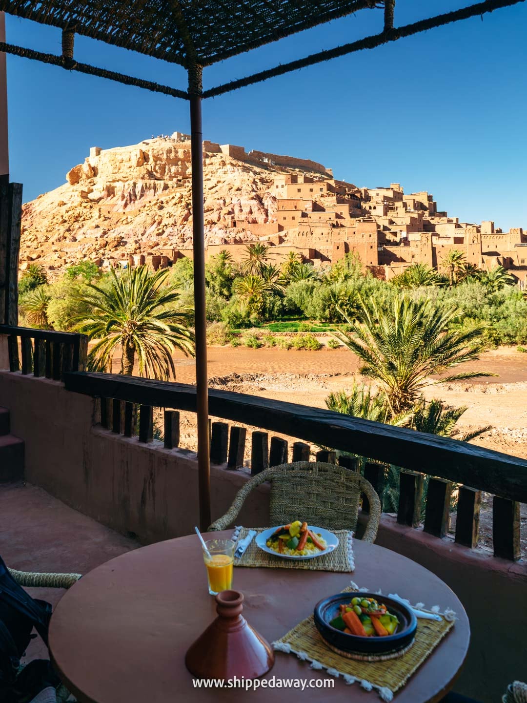 Ait Benhaddou Travel Guide - How to visit Ait Benhaddou - enjoying traditional moroccan food with a view of the town