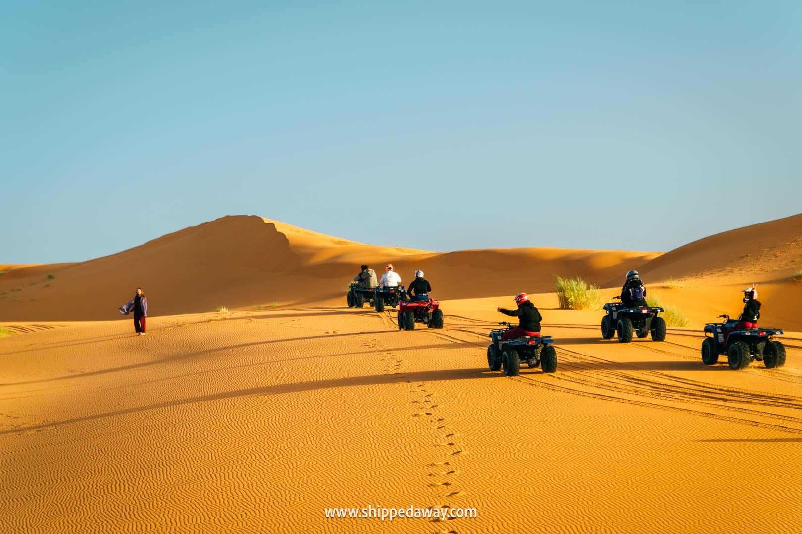 Quads driving across the sand dunes of Merzouga, Morocco's Desert