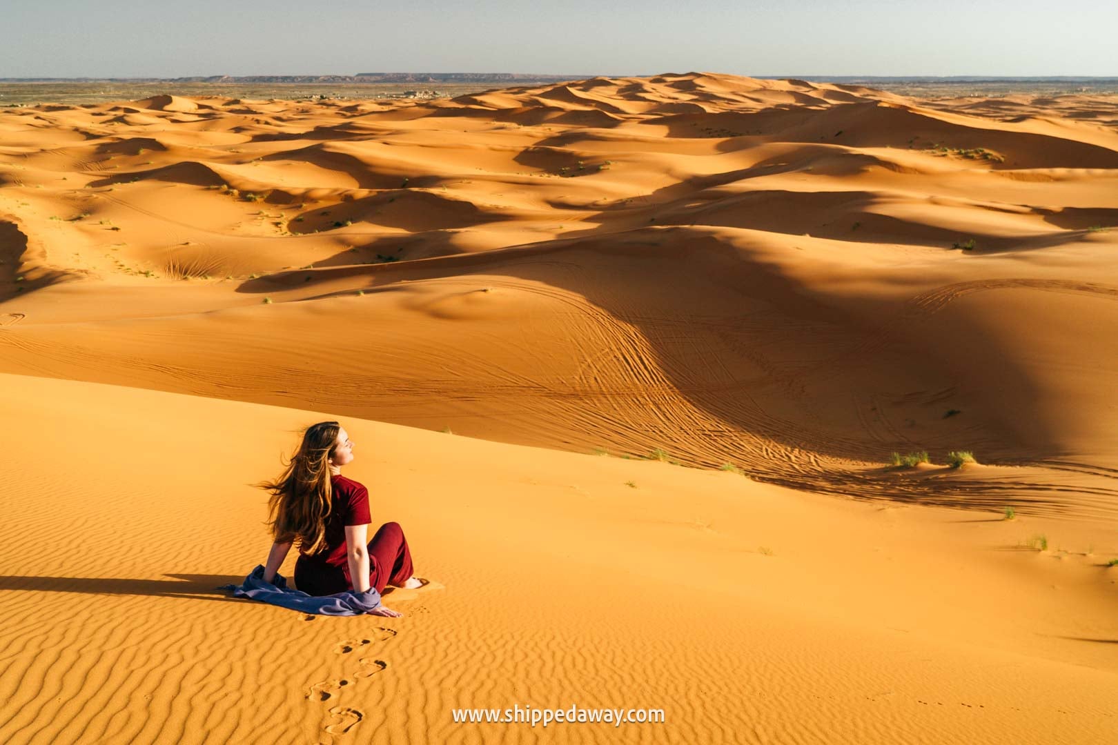 Sitting on the sand dunes in Merzouga, Morocco's Desert